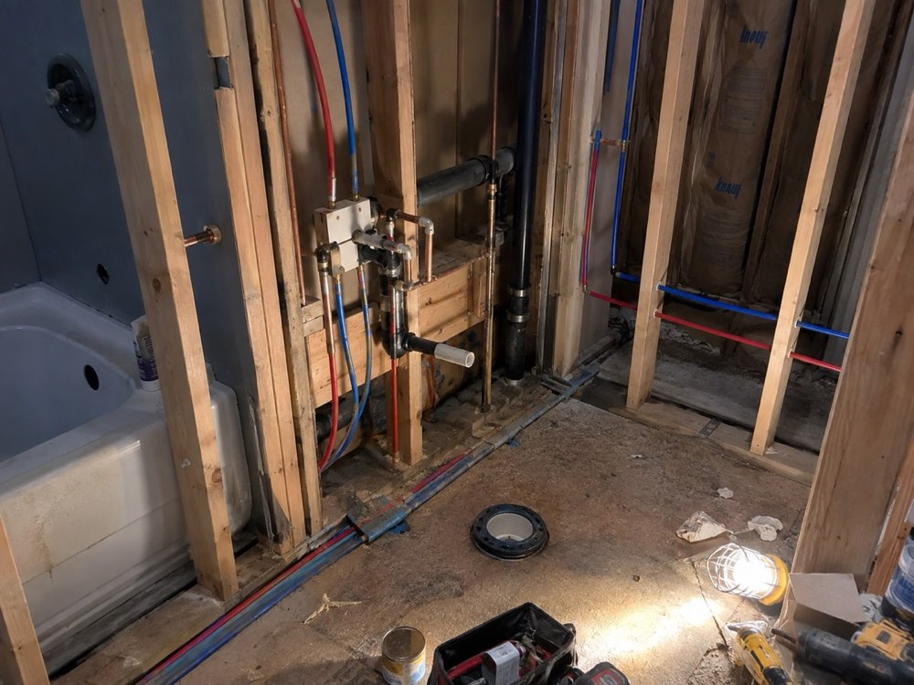 Bathroom rough-in with new supply and drain lines between studs